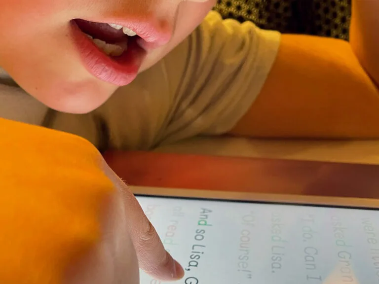 Child reading out-loud with KOBI